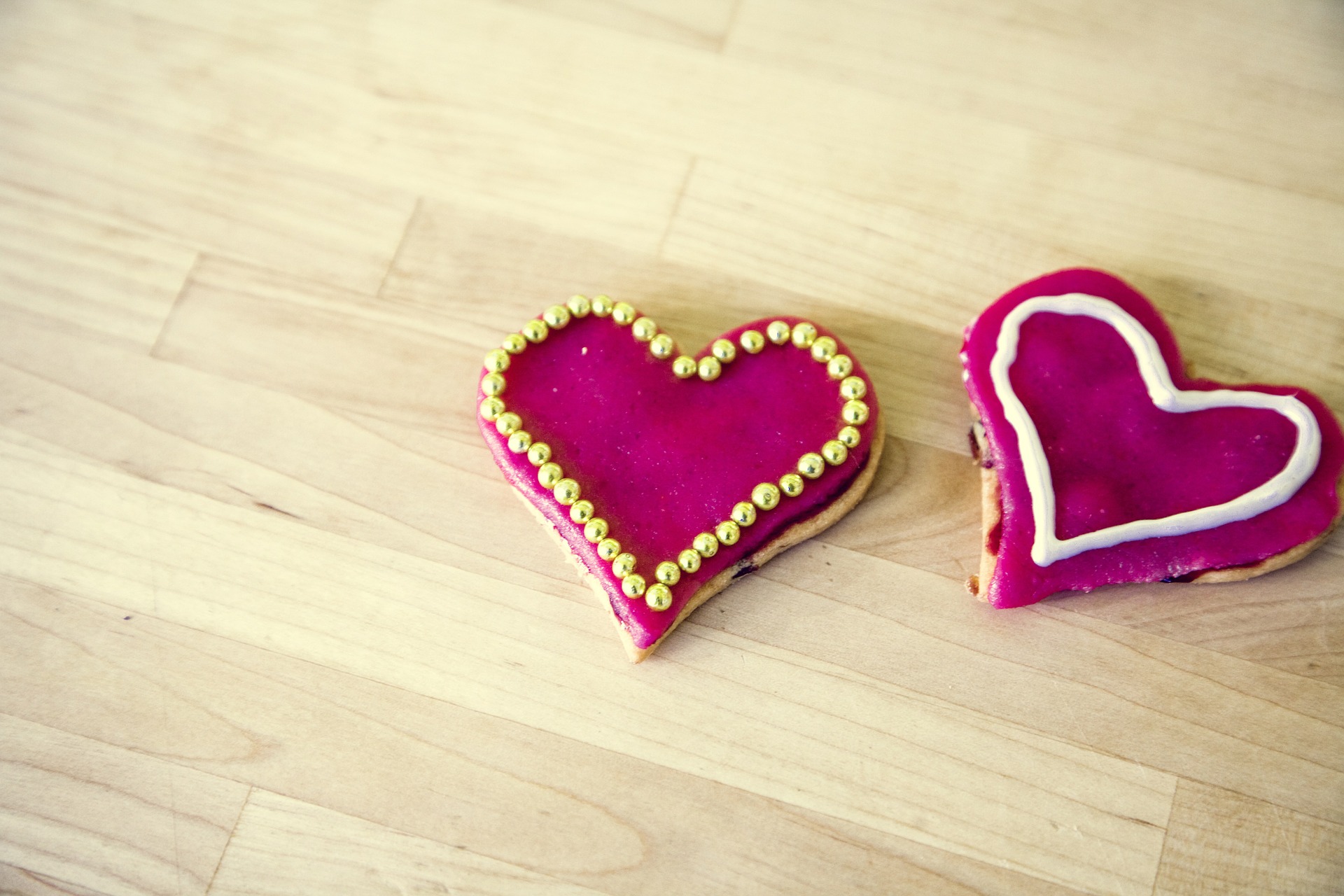 two heart cookies on wooden table